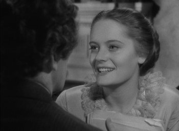 Movie still from “The Adventures of Mark Twain” (1944), directed by Irving Rapper – A young woman smiling at a man in a suit; Close Up shot, Over the shoulder angle