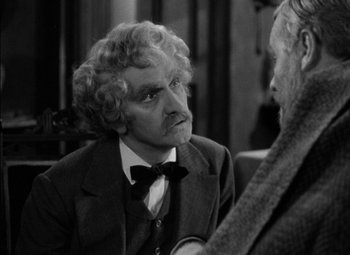 Movie still from “The Adventures of Mark Twain” (1944), directed by Irving Rapper – An older man wearing a suit and bow tie talking to a younger man; Close Up shot, Over the shoulder angle