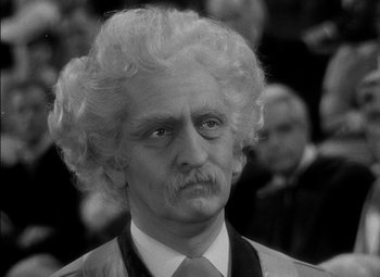 Movie still from “The Adventures of Mark Twain” (1944), directed by Irving Rapper – An old man with a mustache and curly white hair; Close Up shot, Over the shoulder angle