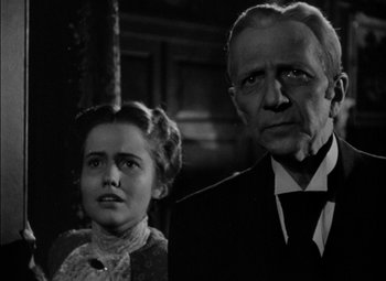 Movie still from “The Adventures of Mark Twain” (1944), directed by Irving Rapper – An older man and a younger woman standing next to each other; Close Up shot, Low angle