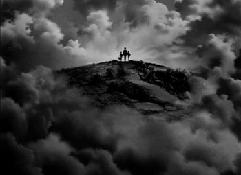 Movie still from “The Adventures of Mark Twain” (1944), directed by Irving Rapper – Two people standing on top of a hill with clouds in the background; Extreme Wide shot, Low angle