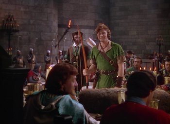 Movie still from “The Adventures of Robin Hood” (1938), directed by William Keighley – A group of people dressed as robin hood and maid marian; Medium shot, Over the shoulder angle