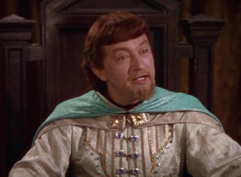 Movie still from “The Adventures of Robin Hood” (1938), directed by William Keighley – A person with a beard wearing a costume; Close Up shot, High angle