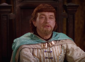 Movie still from “The Adventures of Robin Hood” (1938), directed by William Keighley – A man with a beard wearing a robe and a cape; Close Up shot, Over the shoulder angle