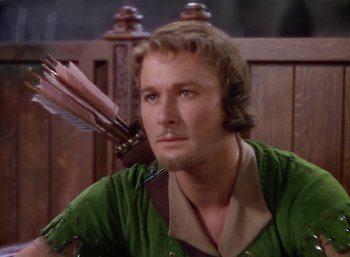 Movie still from “The Adventures of Robin Hood” (1938), directed by William Keighley – A person holding a bow and arrow; Close Up shot, High angle
