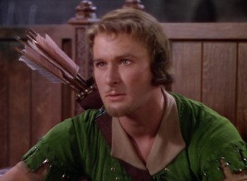 Movie still from “The Adventures of Robin Hood” (1938), directed by William Keighley – A person holding a bow and arrow; Close Up shot, Over the shoulder angle