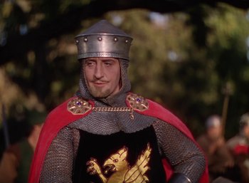 Movie still from “The Adventures of Robin Hood” (1938), directed by William Keighley – A man dressed as a medieval knight in a red cape; Medium shot, Low angle