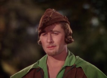 Movie still from “The Adventures of Robin Hood” (1938), directed by William Keighley – A man in a brown hat and a green shirt; Close Up shot, High angle
