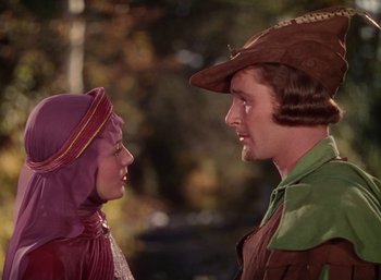 Movie still from “The Adventures of Robin Hood” (1938), directed by William Keighley – A man and a woman dressed in medieval clothing; Medium shot, Over the shoulder angle