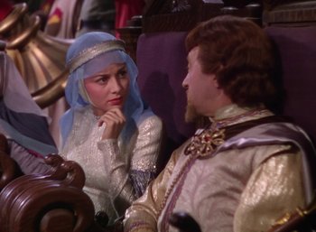 Movie still from “The Adventures of Robin Hood” (1938), directed by William Keighley – A man and a woman sitting next to each other; Medium shot, Over the shoulder angle