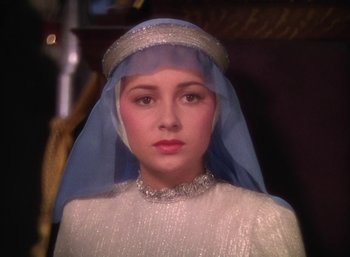 Movie still from “The Adventures of Robin Hood” (1938), directed by William Keighley – A woman wearing a white dress and a blue veil; Close Up shot, Low angle