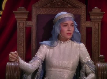 Movie still from “The Adventures of Robin Hood” (1938), directed by William Keighley – A woman wearing a white dress and a blue veil; Medium shot, High angle