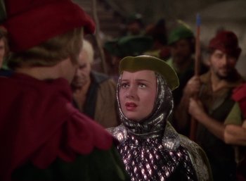 Movie still from “The Adventures of Robin Hood” (1938), directed by William Keighley – A woman dressed as a medieval knight in front of a crowd; Medium shot, High angle