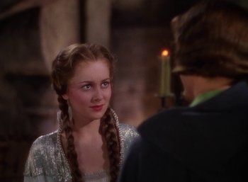 Movie still from “The Adventures of Robin Hood” (1938), directed by William Keighley – A young woman with long braids looking at a young man; Close Up shot, Over the shoulder angle