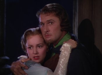 Movie still from “The Adventures of Robin Hood” (1938), directed by William Keighley – A man and a woman are hugging each other; Close Up shot, Low angle