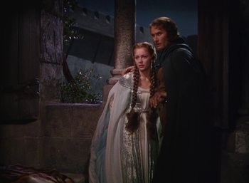 Movie still from “The Adventures of Robin Hood” (1938), directed by William Keighley – A man and a woman standing next to each other; Medium shot, High angle