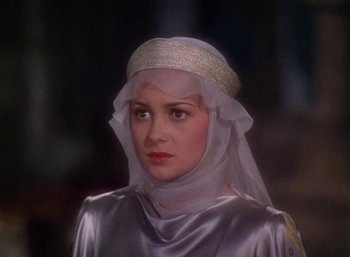 Movie still from “The Adventures of Robin Hood” (1938), directed by William Keighley – A woman wearing a white veil and a silver dress; Close Up shot, Over the shoulder angle