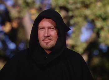 Movie still from “The Adventures of Robin Hood” (1938), directed by William Keighley – A man wearing a black robe and a black hood; Close Up shot, Low angle