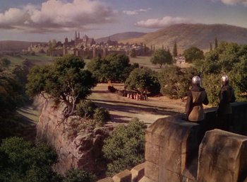 Movie still from “The Adventures of Robin Hood” (1938), directed by William Keighley – An oil painting of a man sitting on a wall overlooking a city; Extreme Wide shot, High angle