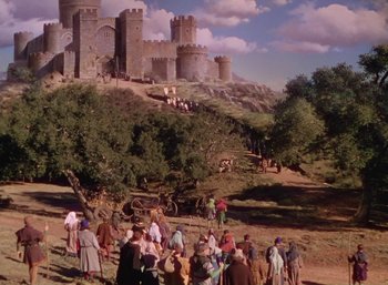 Movie still from “The Adventures of Robin Hood” (1938), directed by William Keighley – A group of people standing in front of a castle; Extreme Wide shot, High angle