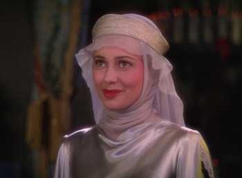 Movie still from “The Adventures of Robin Hood” (1938), directed by William Keighley – A woman in a silver dress with a veil on her head; Close Up shot, Low angle