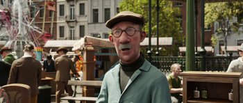 Movie still from “The Adventures of Tintin” (2011), directed by Steven Spielberg – An old man with a mustache wearing a hat and glasses; Close Up shot, Over the shoulder angle
