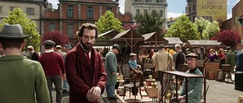 Movie still from “The Adventures of Tintin” (2011), directed by Steven Spielberg – A group of people standing around a market; Medium shot, Over the shoulder angle