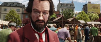 Movie still from “The Adventures of Tintin” (2011), directed by Steven Spielberg – A man with a beard wearing a red suit and a red tie; Close Up shot, Over the shoulder angle