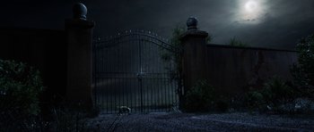 Movie still from “The Adventures of Tintin” (2011), directed by Steven Spielberg – A dog is standing in front of a gate; Extreme Wide shot, Low angle