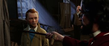 Movie still from “The Adventures of Tintin” (2011), directed by Steven Spielberg – A person holding a wand over another person's face; Medium shot, Over the shoulder angle