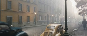 Movie still from “The Adventures of Tintin” (2011), directed by Steven Spielberg – An old car parked on the side of the street; Wide shot, High angle