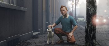 Movie still from “The Adventures of Tintin” (2011), directed by Steven Spielberg – A man kneeling down next to a small dog; Medium shot, High angle