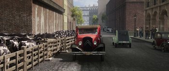 Movie still from “The Adventures of Tintin” (2011), directed by Steven Spielberg – An old red truck parked in the middle of a street; Extreme Wide shot, High angle