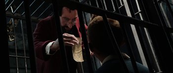 Movie still from “The Adventures of Tintin” (2011), directed by Steven Spielberg – A man holding onto a piece of paper in front of another man; Medium shot, Over the shoulder angle