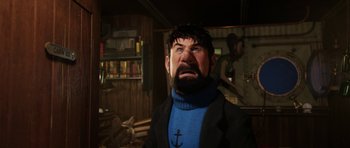 Movie still from “The Adventures of Tintin” (2011), directed by Steven Spielberg – A man with a beard and a blue sweater is in a room; Close Up shot, Low angle