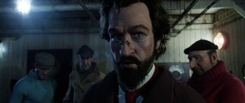 Movie still from “The Adventures of Tintin” (2011), directed by Steven Spielberg – A person with a beard wearing glasses; Close Up shot, Over the shoulder angle