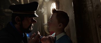Movie still from “The Adventures of Tintin” (2011), directed by Steven Spielberg – A man in a uniform and a boy in a uniform; Close Up shot, Over the shoulder angle