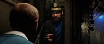 Movie still from “The Adventures of Tintin” (2011), directed by Steven Spielberg – A man wearing a sailor's hat talking to another man; Medium shot, Over the shoulder angle