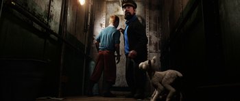 Movie still from “The Adventures of Tintin” (2011), directed by Steven Spielberg – A man and a boy standing next to each other in front of an elevator; Medium shot, Low angle