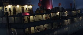 Movie still from “The Adventures of Tintin” (2011), directed by Steven Spielberg – A man standing on the side of a boat at night; Extreme Wide shot, High angle