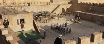 Movie still from “The Adventures of Tintin” (2011), directed by Steven Spielberg – A group of men in uniform marching on a field; Extreme Wide shot, High angle