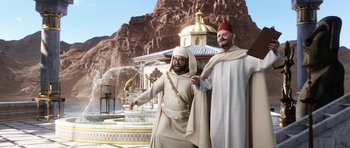 Movie still from “The Adventures of Tintin” (2011), directed by Steven Spielberg – A couple of men standing next to each other in front of a fountain; Wide shot, Low angle