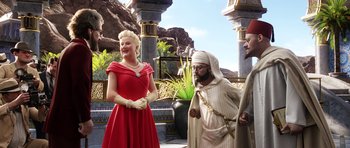 Movie still from “The Adventures of Tintin” (2011), directed by Steven Spielberg – A woman in a red dress and a man in a white robe; Medium shot, Over the shoulder angle
