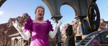 Movie still from “The Adventures of Tintin” (2011), directed by Steven Spielberg – A woman in a purple dress standing next to a statue; Medium shot, Low angle