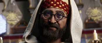 Movie still from “The Adventures of Tintin” (2011), directed by Steven Spielberg – A man with a beard wearing glasses and a crown; Close Up shot, Low angle