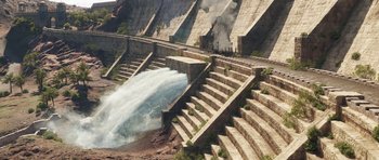 Movie still from “The Adventures of Tintin” (2011), directed by Steven Spielberg – A large waterfall pouring water into a body of water next to stairs; Extreme Wide shot, High angle