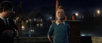 Movie still from “The Adventures of Tintin” (2011), directed by Steven Spielberg – A man standing in front of a brick building at night; Medium shot, High angle