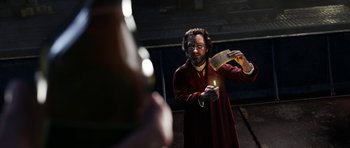 Movie still from “The Adventures of Tintin” (2011), directed by Steven Spielberg – A man holding a candle in front of another man; Medium shot, Low angle