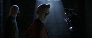 Movie still from “The Adventures of Tintin” (2011), directed by Steven Spielberg – A young man with a mohawk haircut standing in a dark room; Close Up shot, Over the shoulder angle