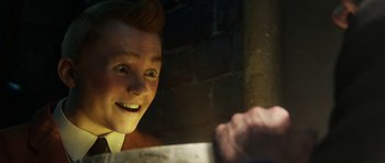 Movie still from “The Adventures of Tintin” (2011), directed by Steven Spielberg – A young man smiling while holding a knife; Close Up shot, Over the shoulder angle